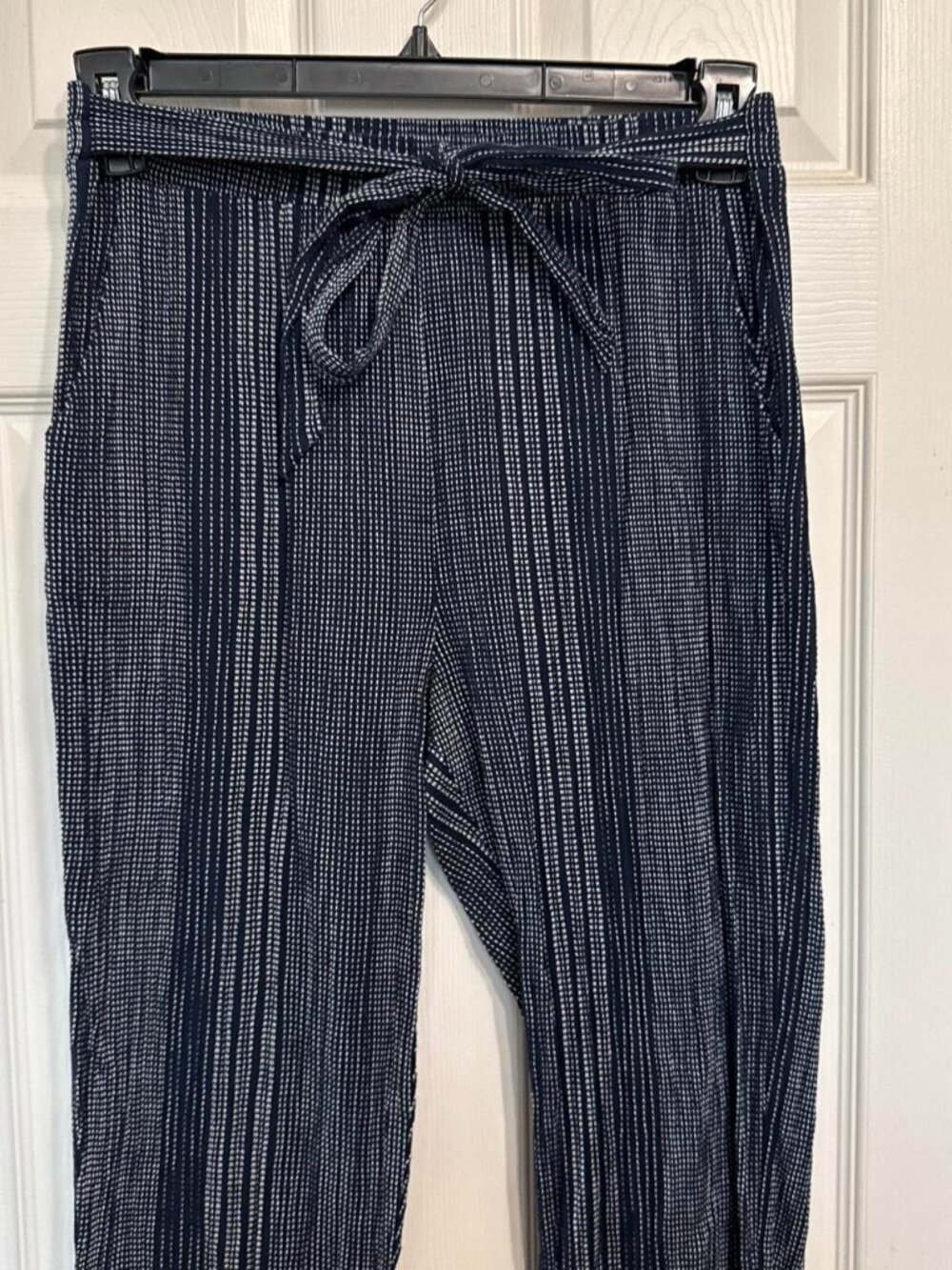 Navy blue and white checkered pants with tie waist and rolled cuffs